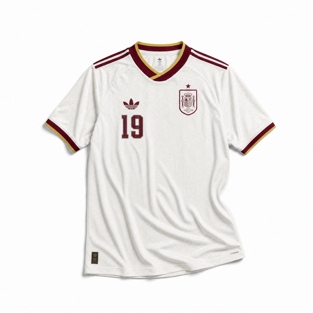Maglia Lamine Yamal Spagna Away 2026 World Cup Winner vista frontale con design bianco e dettagli rossi, gialli e blu.
